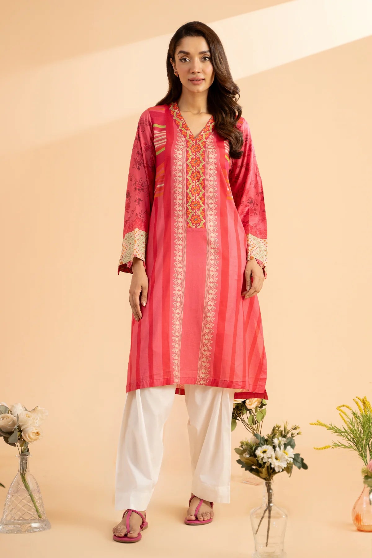 A woman wearing a Congo Pink printed lawn shirt from Charizma – a perfect choice for Pakistani suits online in Canada.