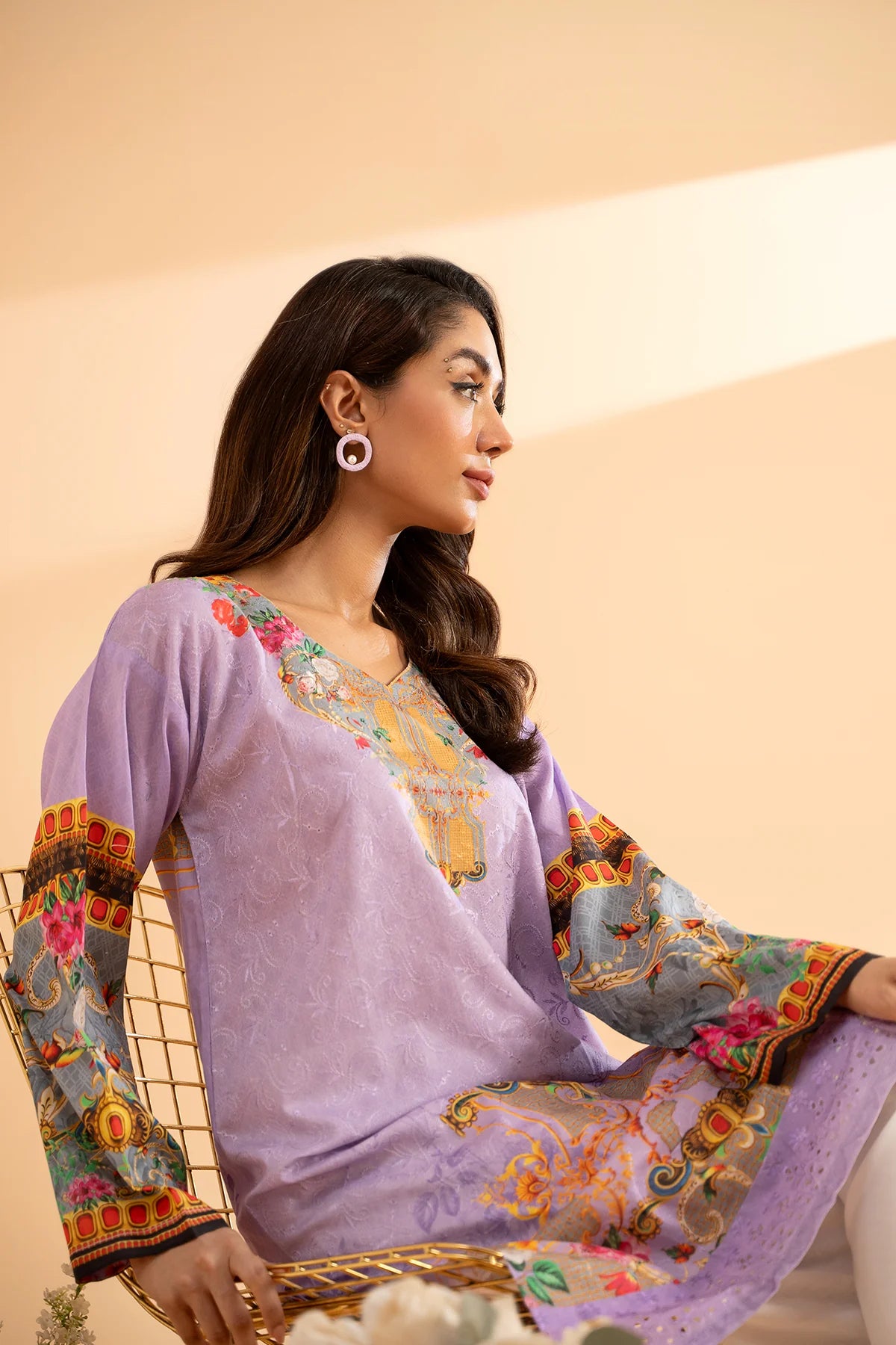 lady sitting wearing Purple lawn shirt by Charizma, featuring intricate print details – a perfect casual outfit for Pakistani suits Canada.