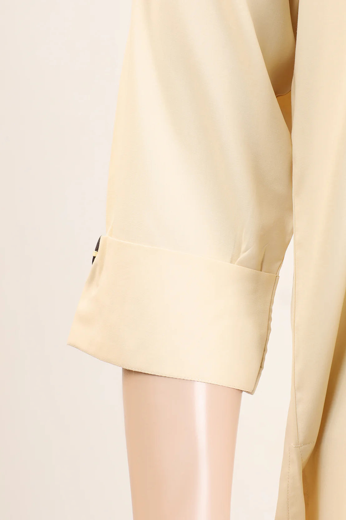 sleeves Close-up of Saya’s finely stitched beige kurta and trouser set, a great addition to your wardrobe of traditional Pakistani clothes.