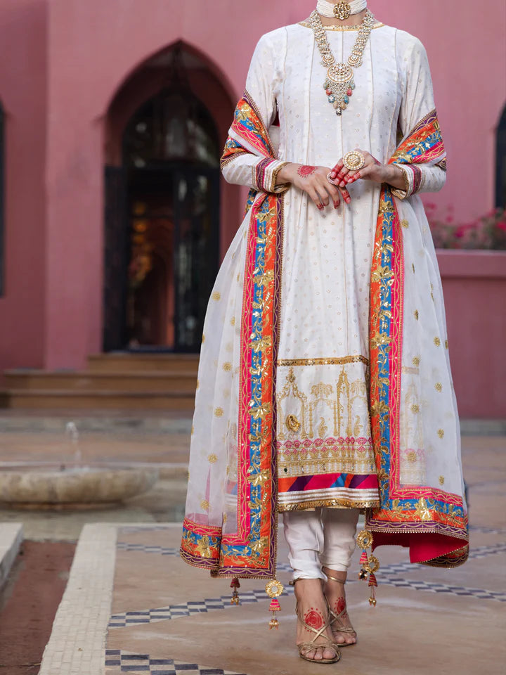 A woman wearing a medium-size Almirah off-white embroidered chiffon suit – a premium choice for Pakistani suits online in Canada.