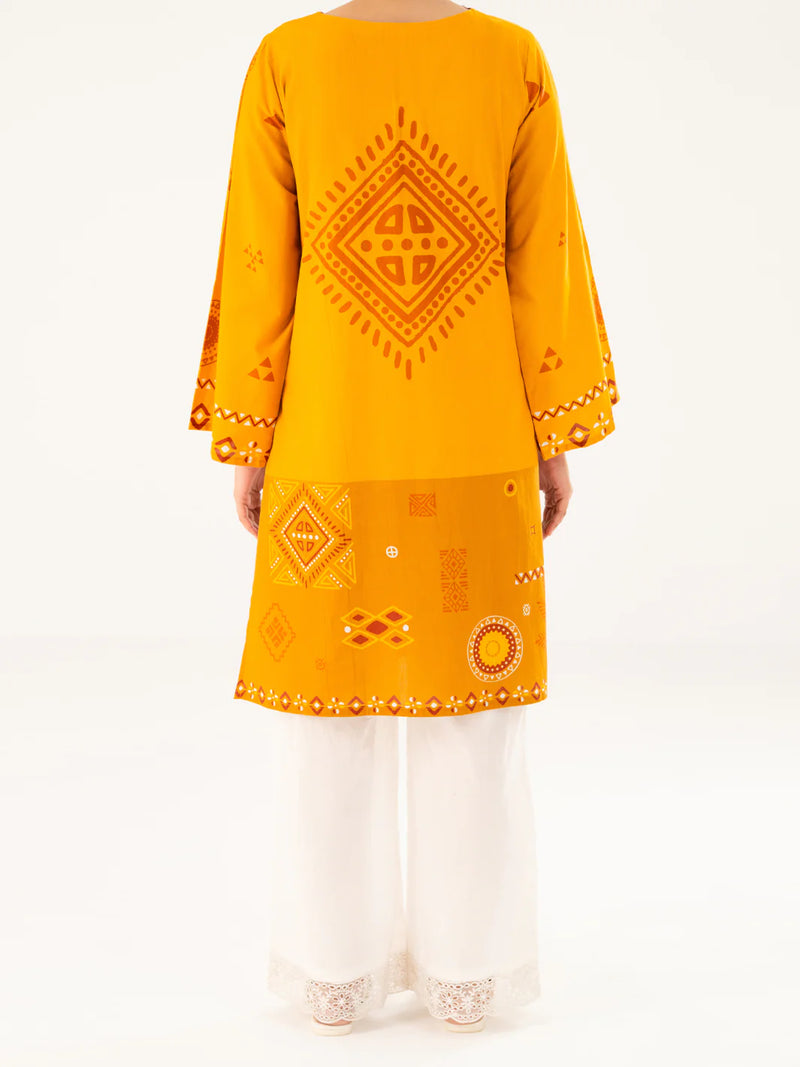 Woman standing back view full length mustard cambric kurti large medallion print mirror hem border Almirah Eid Pakistani suits online Canada