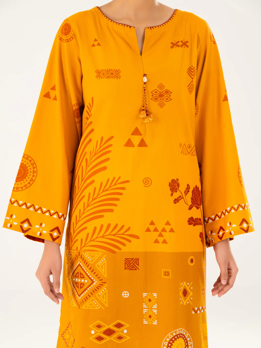 Woman close-up upper body front mustard cambric kurti tassel neckline mirror embroidered cuffs Almirah festive Pakistani suits Canada women