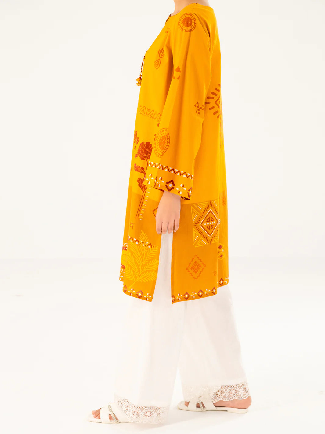 Woman standing side view full length mustard geometric cambric kurti side slit wide sleeves Almirah Eid Diwali Pakistani suits Canada