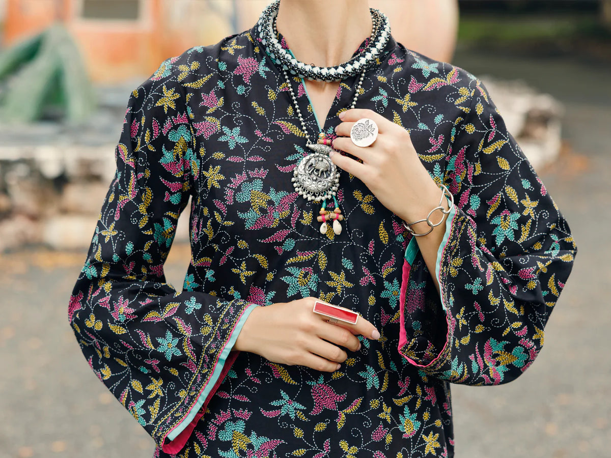 Woman close-up upper body front black floral lawn kurti keyhole tassel neckline contrast cuff lining Almirah Eid Diwali Pakistani suits Canada