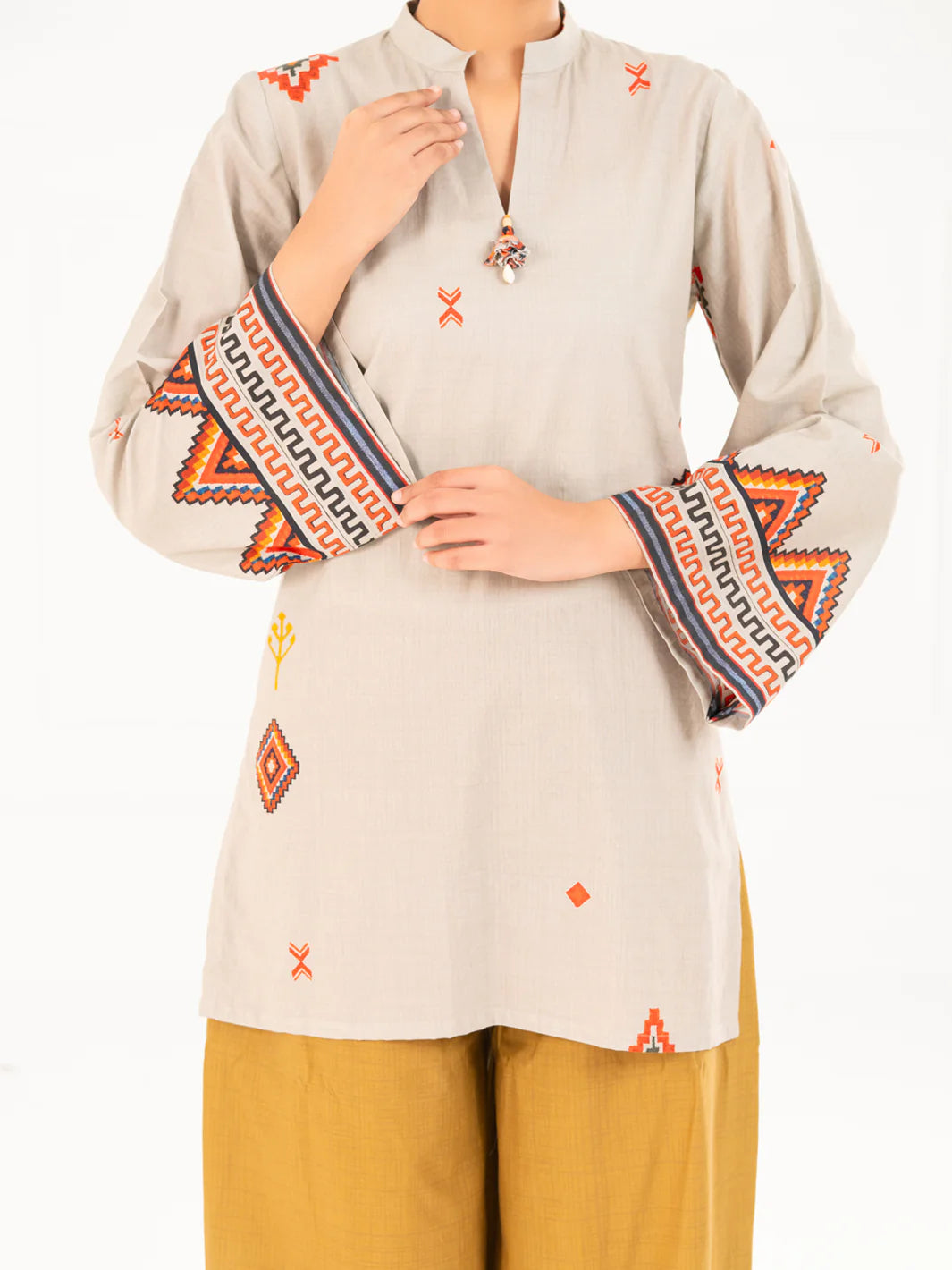 Close-up portrait Almirah beige cambric kurti geometric embroidered sleeves detail women Eid Pakistani suits online Canada