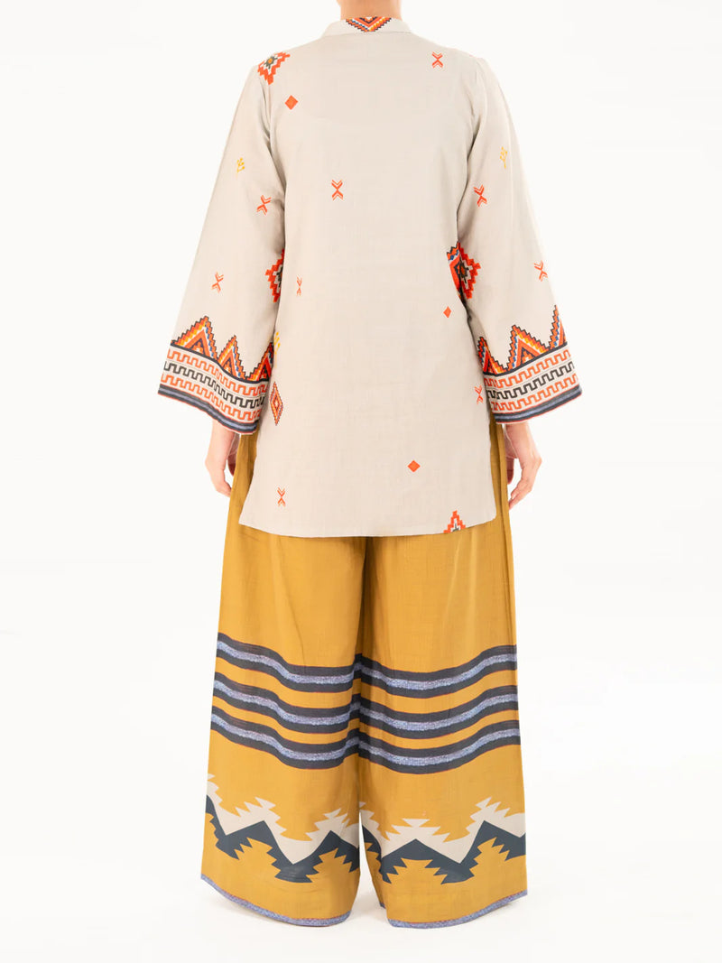 Woman standing full length back view Almirah beige printed cambric kurti embroidered sleeves Pakistani suits online Canada