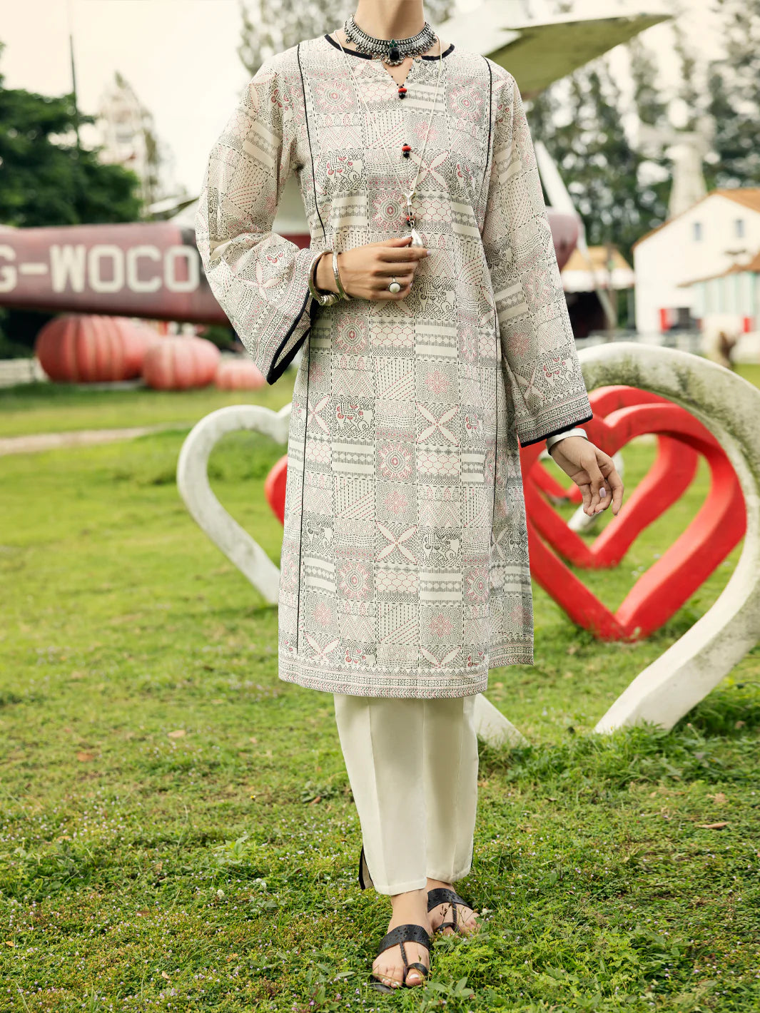 Woman standing full length front view Almirah off white foam printed lawn kurti Eid Diwali Pakistani suits Canada