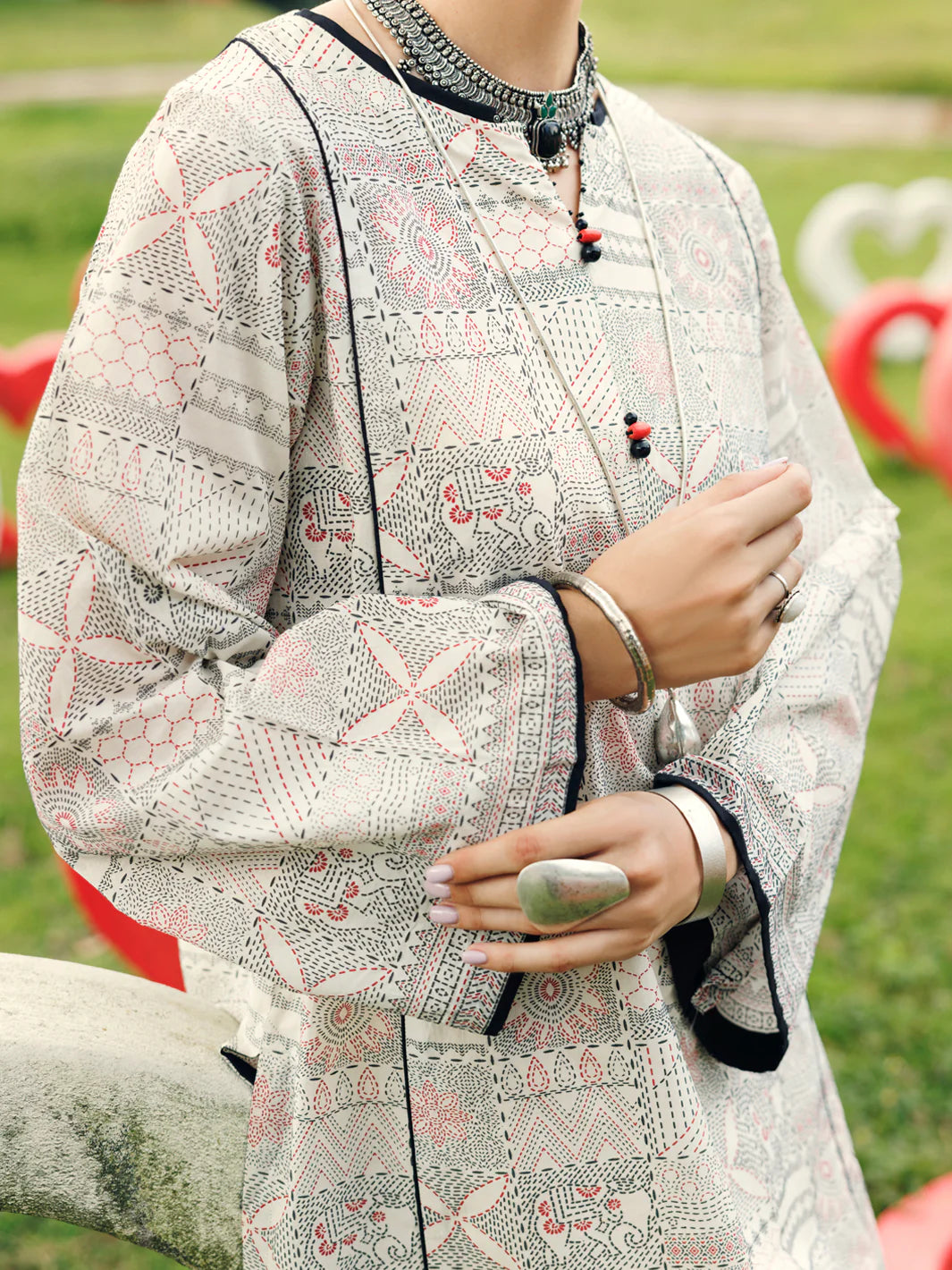 Woman standing three-quarter front view Almirah off white printed lawn kurti festive Eid Diwali Pakistani suits Canada