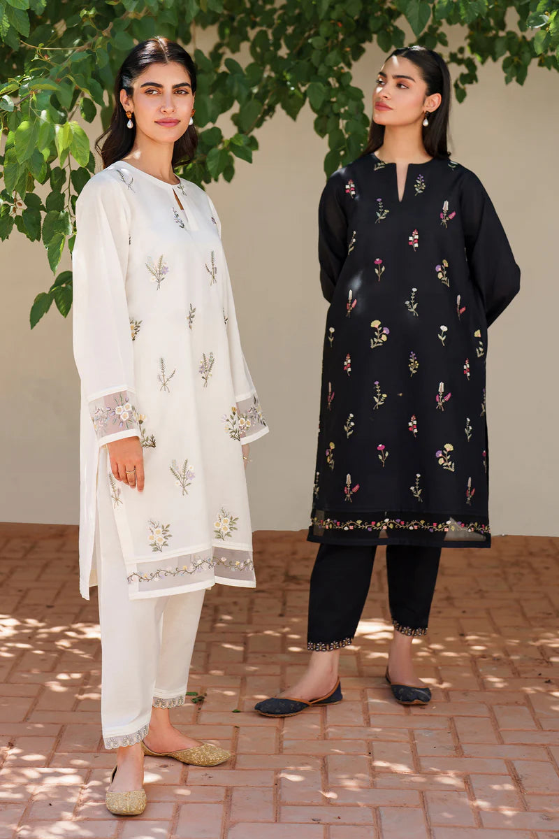 Two models wearing Baroque embroidered lawn suits - off white floral set and black floral set showcasing elegant Pakistani formal wear styling