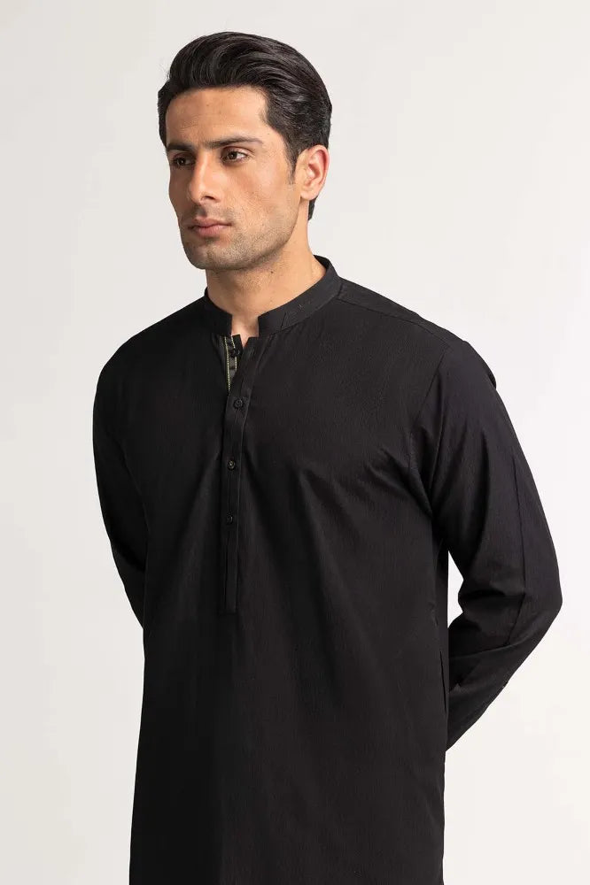 Side profile of GulAhmed’s black blended suit, showcasing its elegant tailoring – perfect for Pakistani suits for men in Canada.