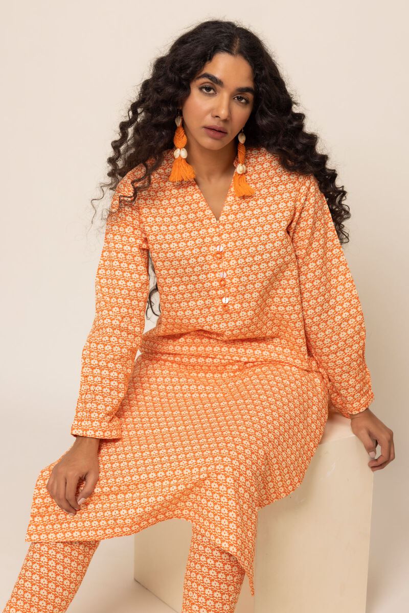 SITTING view of the smart-fit orange cotton kurta by Khaadi, a great choice for Pakistani suits online in Canada.