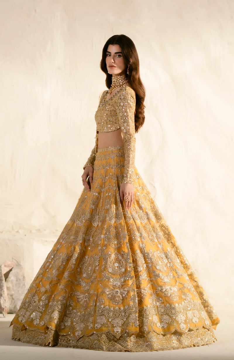 Side view of golden embroidered lehenga showcasing detailed craftsmanship and elegant silhouette with traditional Indian bridal wear styling.