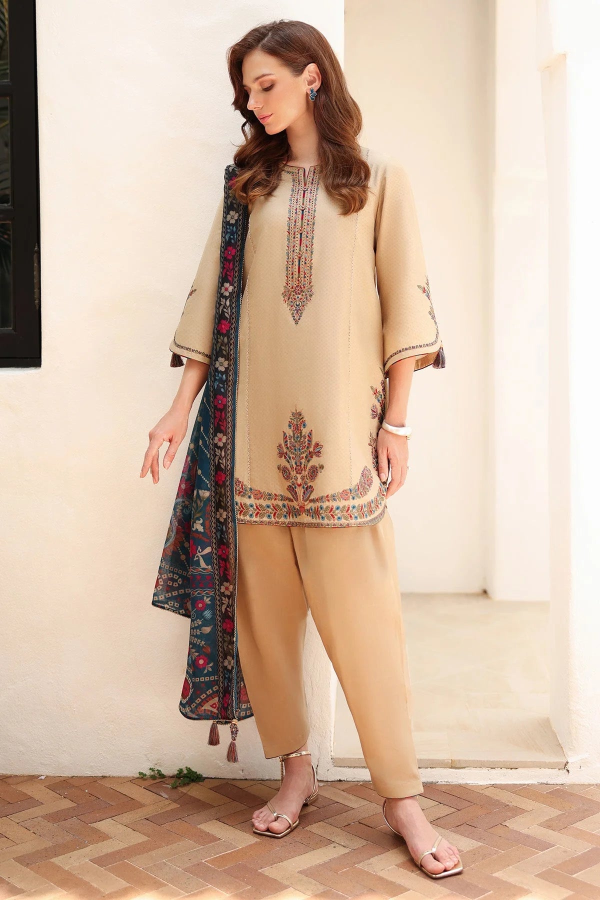 Woman leaning full length – Jazmin JAZ-419 beige embroidered 3-piece Punjabi suit – Pakistani suits online Canada