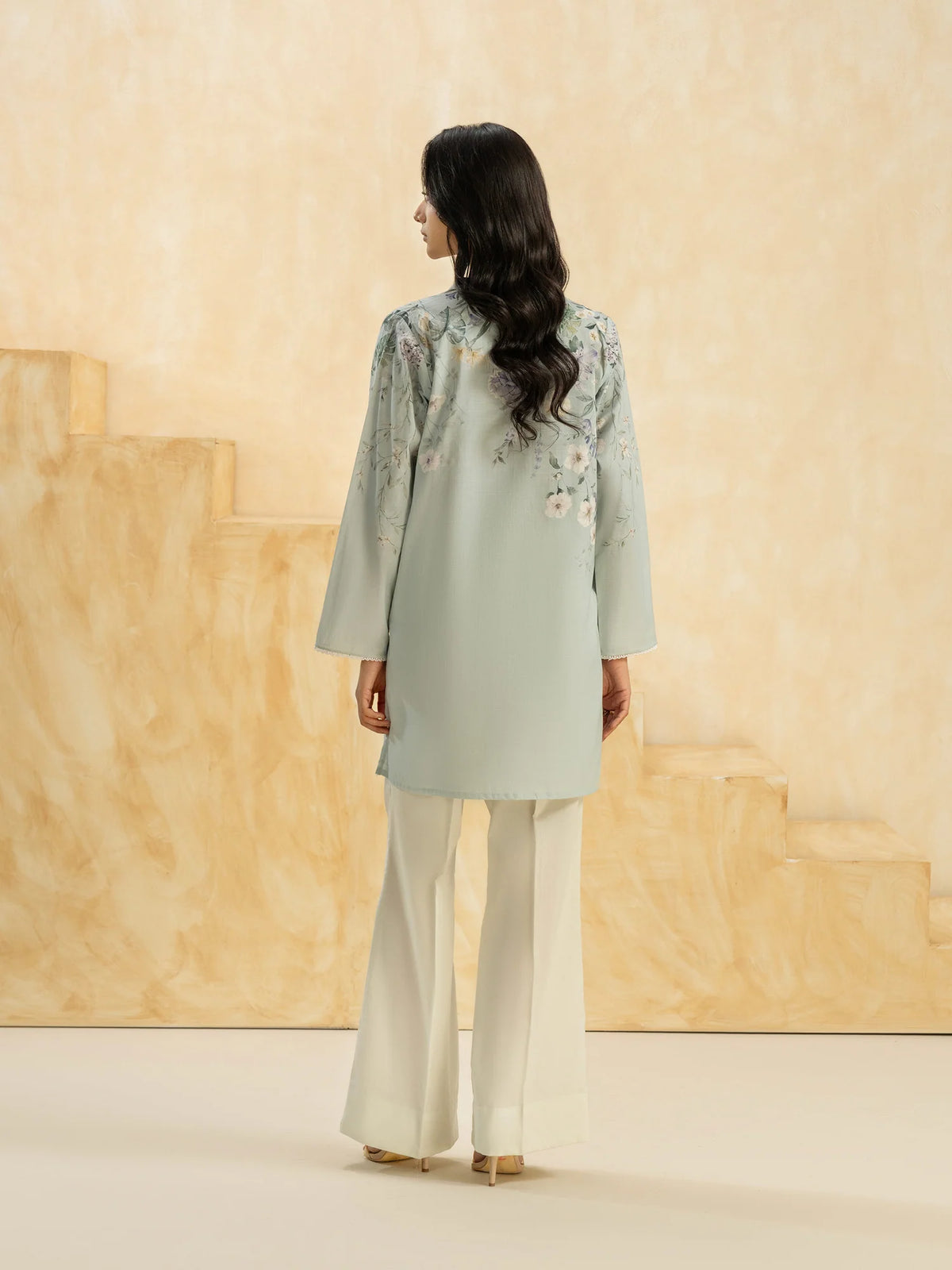Woman standing back view full length sky blue printed slub cambric casual top lace cuff Limelight Eid Pakistani suits Canada