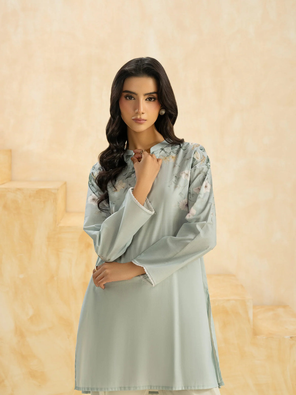 Woman portrait close-up front view hand at neckline sky blue floral cambric casual top Limelight Eid Diwali Pakistani suits Canada