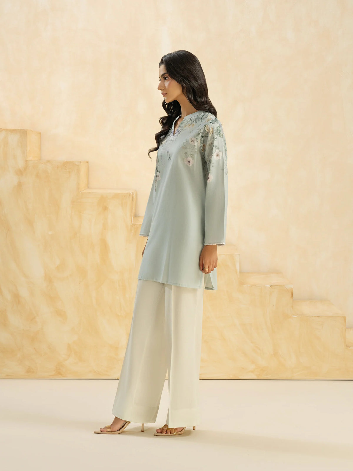Woman standing side view full length sky blue printed cambric casual top Limelight festive Eid Pakistani suits online Canada women
