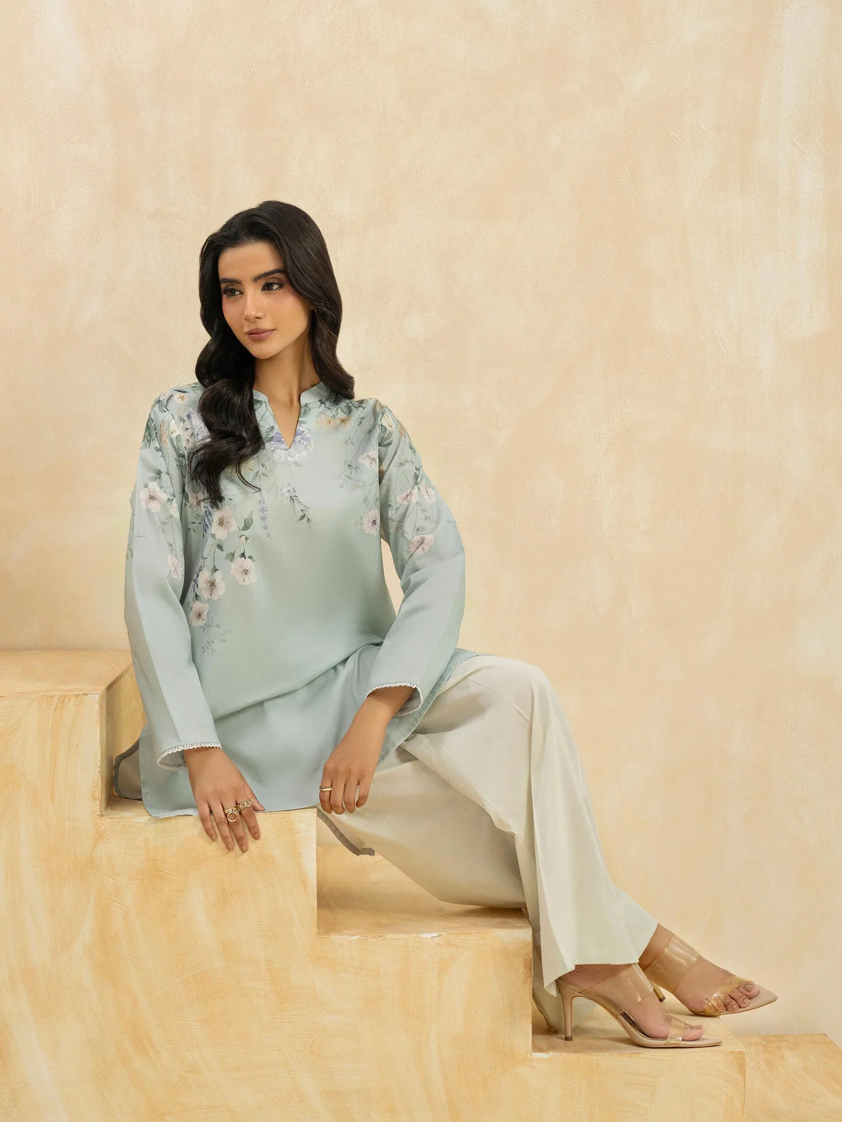 Woman sitting front view upper body sky blue floral print cambric casual top lace cuff Limelight Diwali Pakistani suits Canada