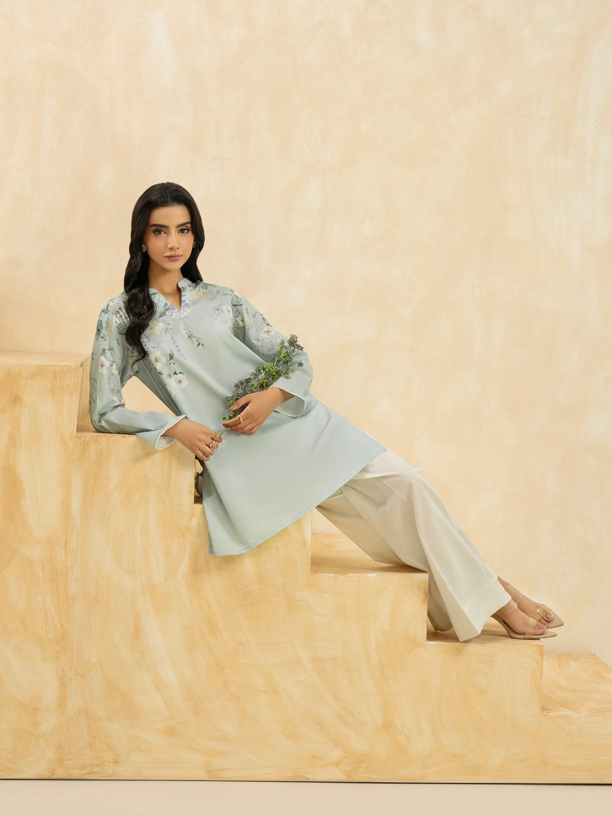 Woman sitting full length front view sky blue printed slub cambric casual top Limelight Eid festive Pakistani suits online Canada