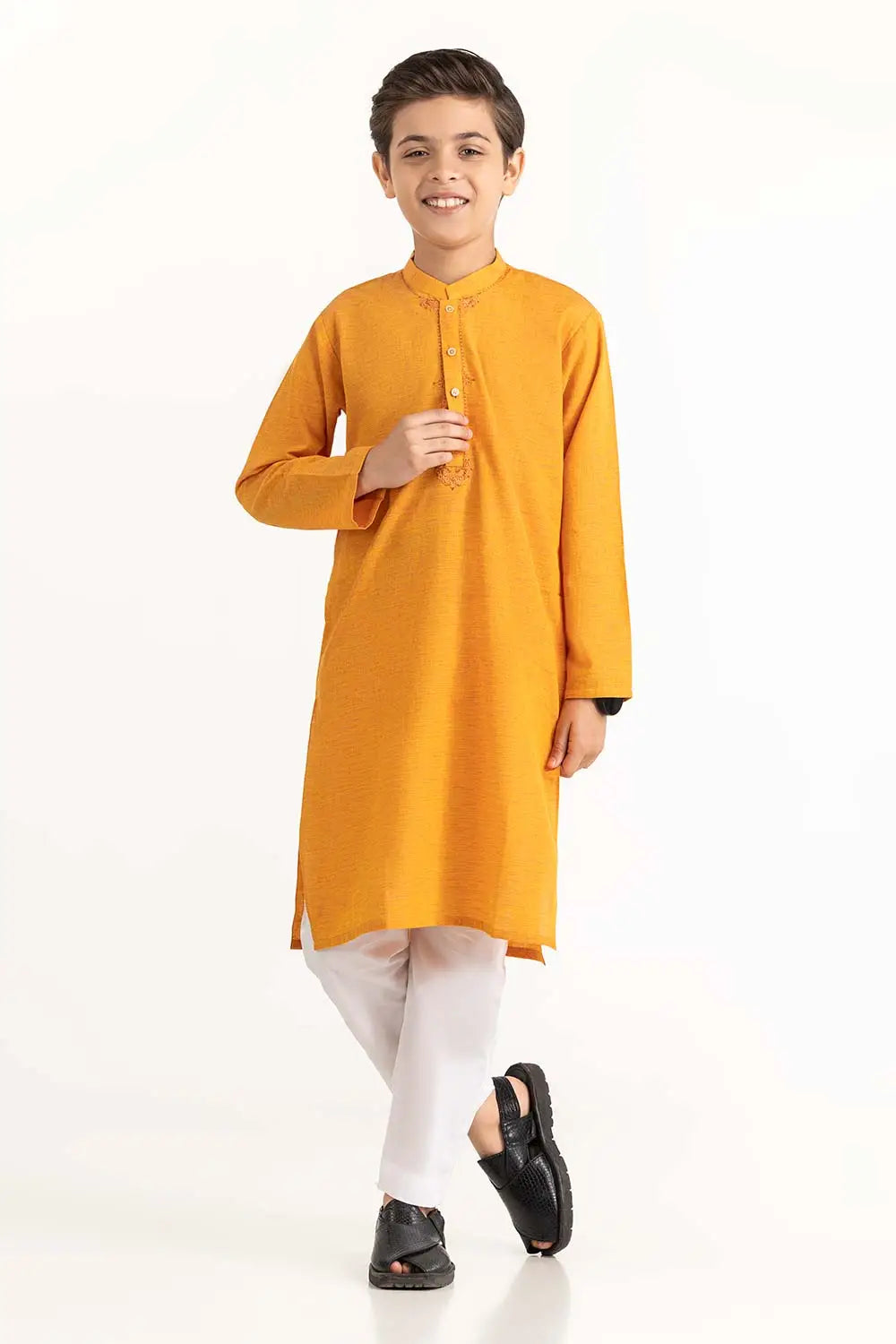 Front View of a young boy wearing a marigold embroidered cotton kurta from Gulahmed – a traditional Pakistani outfit for kids.