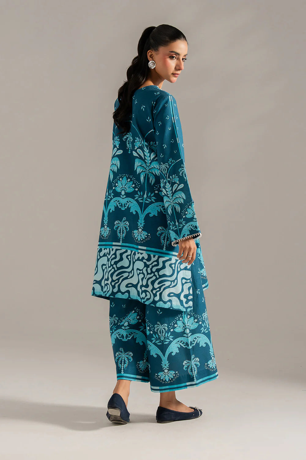 Woman standing back view full length teal blue khaddar 2-piece suit Maryum N Maria festive Diwali Pakistani suits Canada