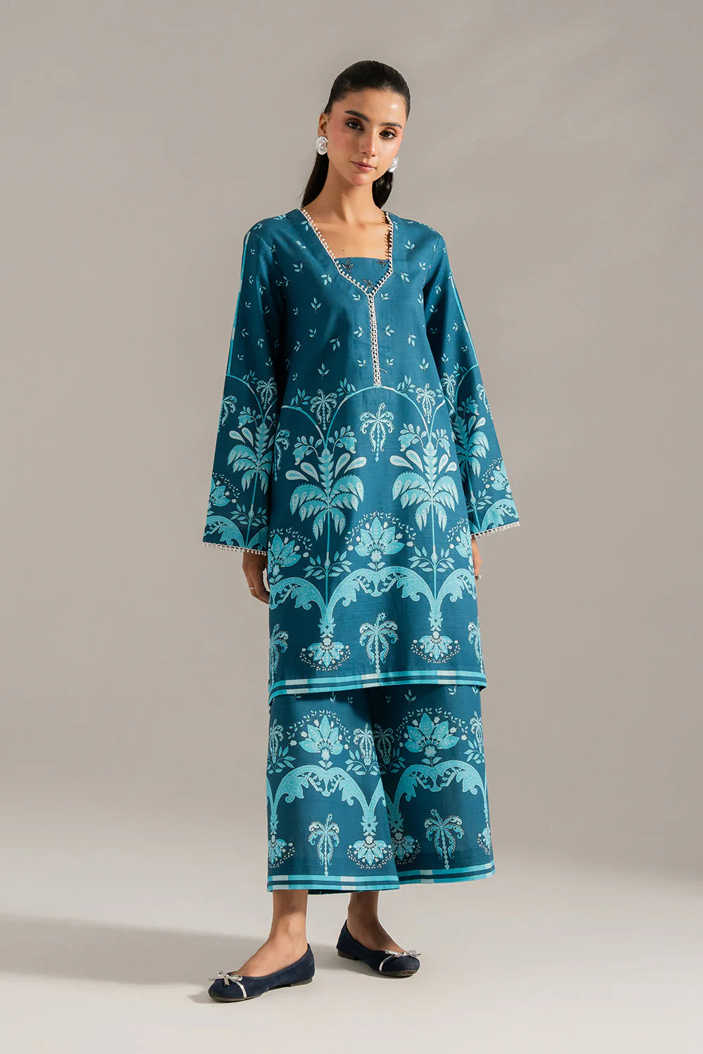 Woman standing front view full length teal printed khaddar suit Maryum N Maria Eid festive Pakistani suits online Canada