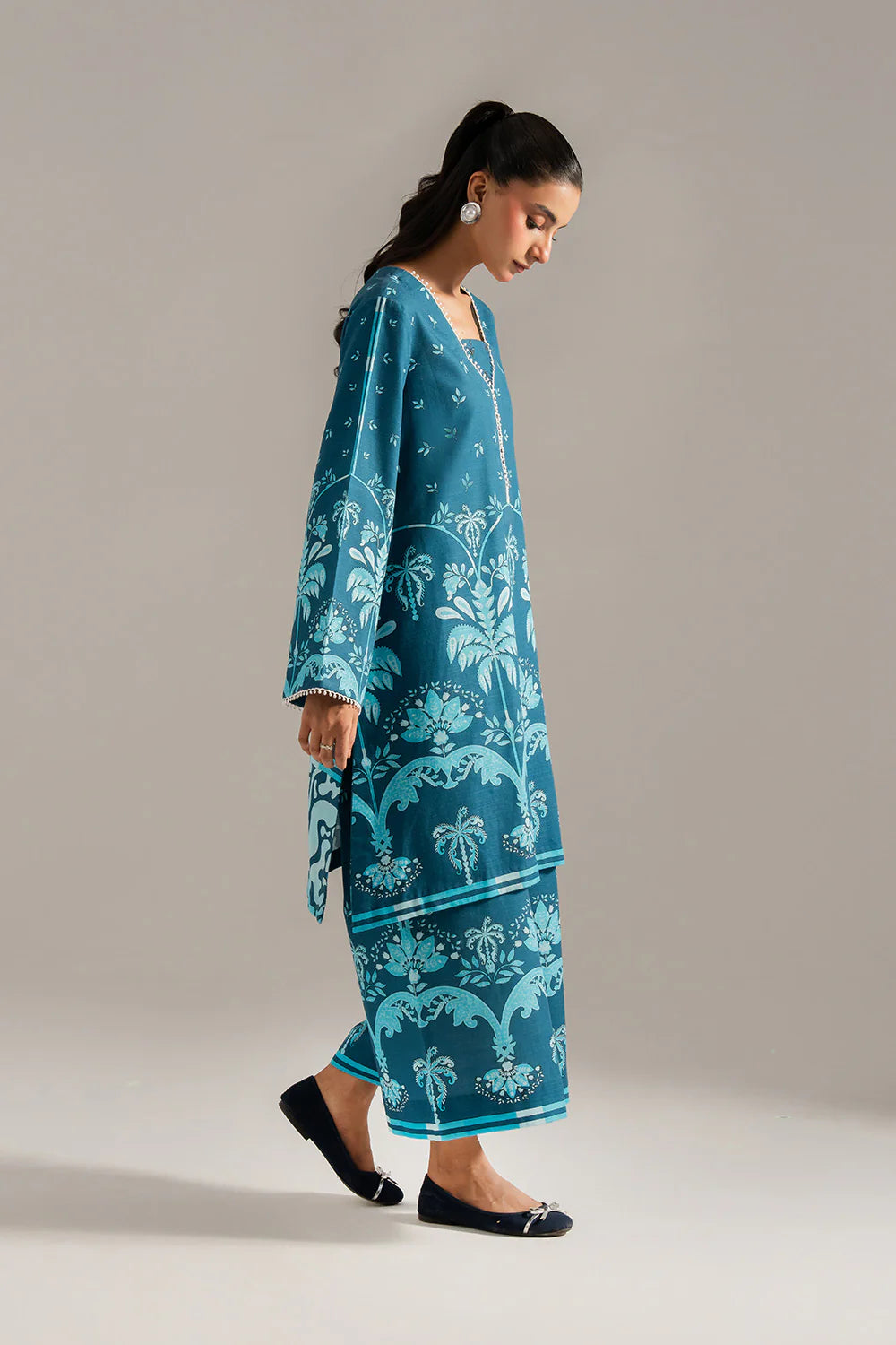 Woman walking side view full length teal blue khaddar 2-piece suit Maryum N Maria Eid Diwali Pakistani suits Canada