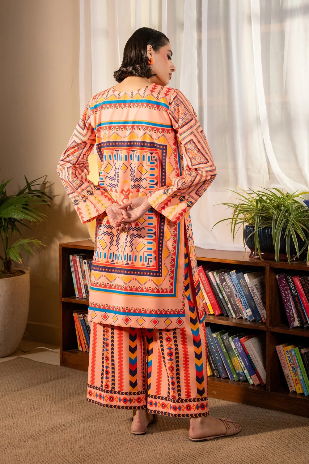 Woman standing back view full length peach geometric print crepe suit Maryum N Maria festive Diwali Pakistani suits online Canada