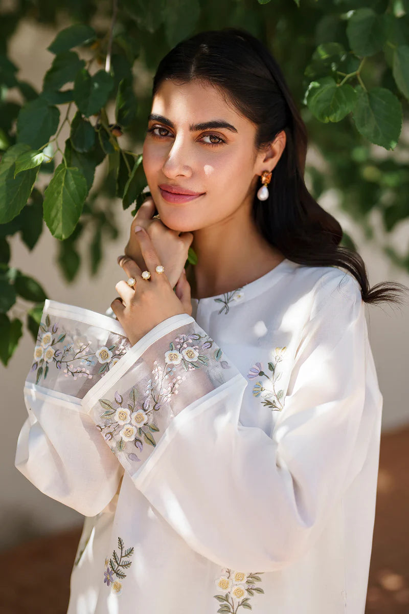 Close-up of off white lawn shirt showcasing intricate floral embroidery, delicate sleeve details, and traditional Pakistani craftsmanship