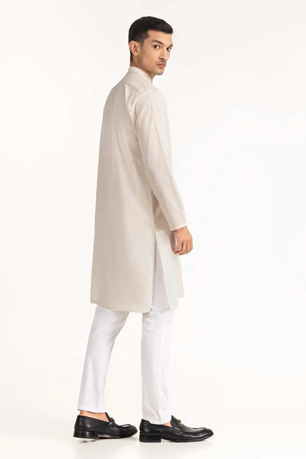 Side profile of GulAhmed’s pastel peach kurta, a premium pick for Pakistani suits for men in Canada with a comfortable fit.