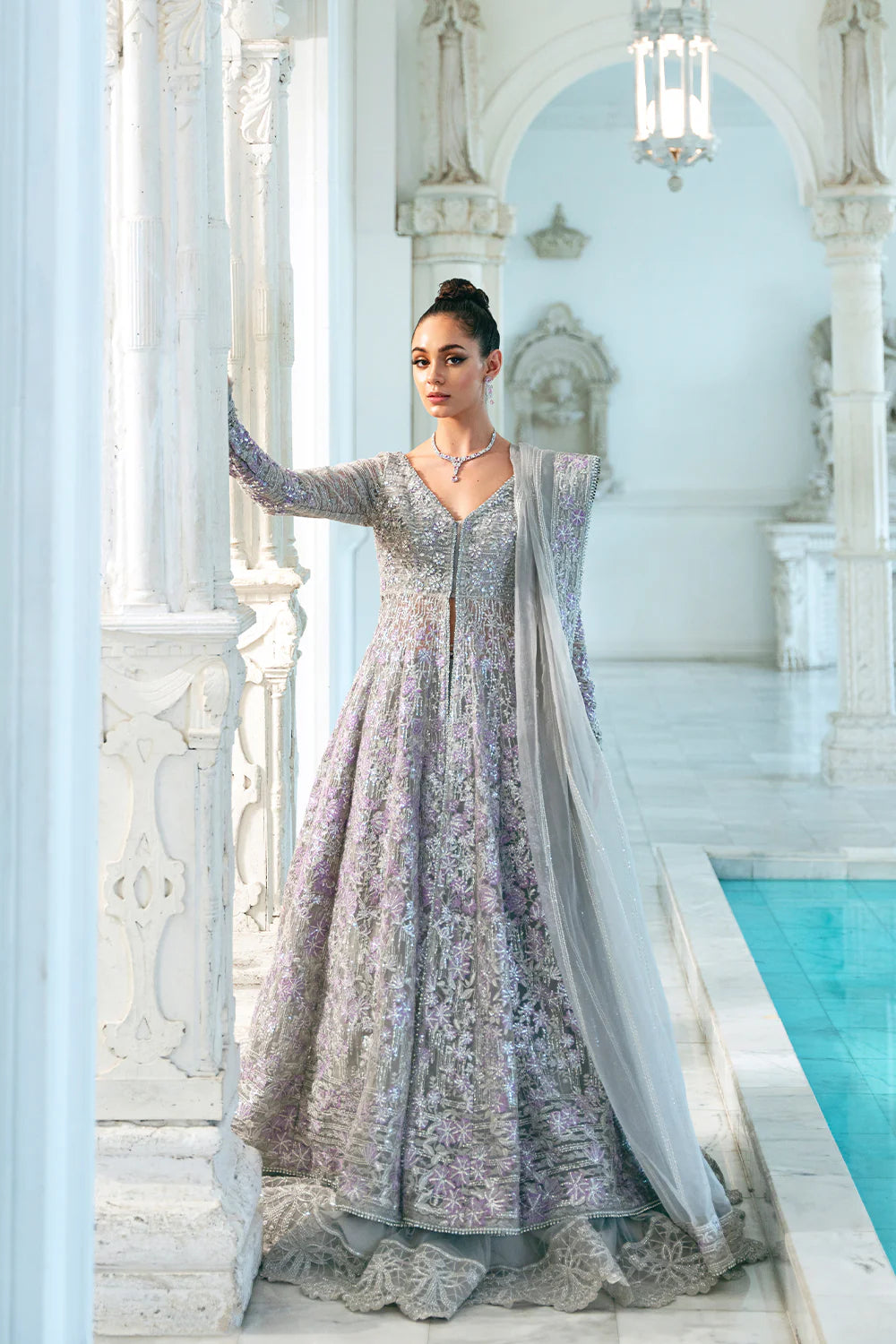 Medium-size woman wearing Saira Rizwan glamorous grey organza bridal dress, showcasing traditional Pakistani clothes online in Canada.