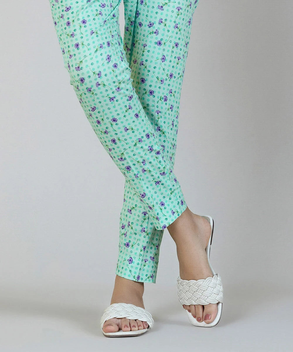 Woman standing close-up in Sapphire aqua floral printed cambric cigarette pants – Pakistani suits Canada
