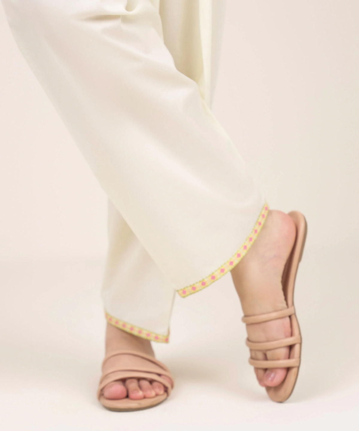 Woman walking angled front view Sapphire beige embroidered cambric shalwar geometric border – Pakistani suits Canada
