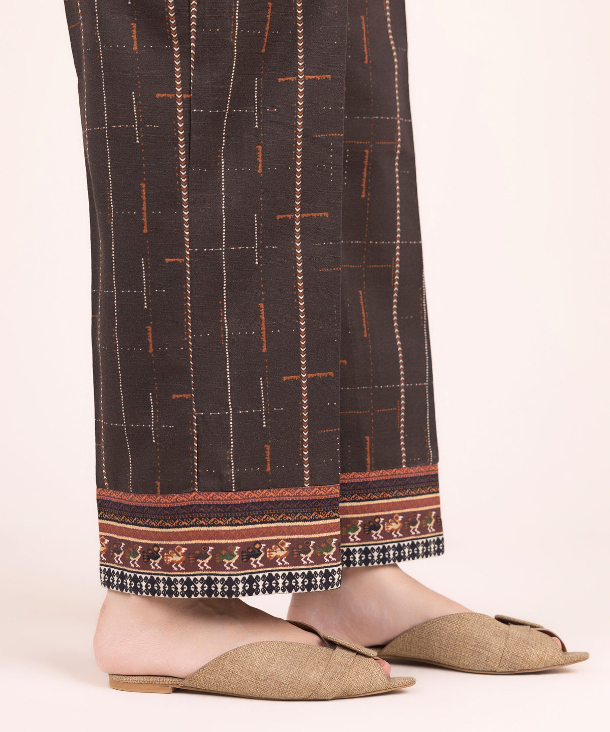 Woman side view standing Sapphire brown cotton Pakistani suits online Canada wide-leg pants tribal diamond hem
