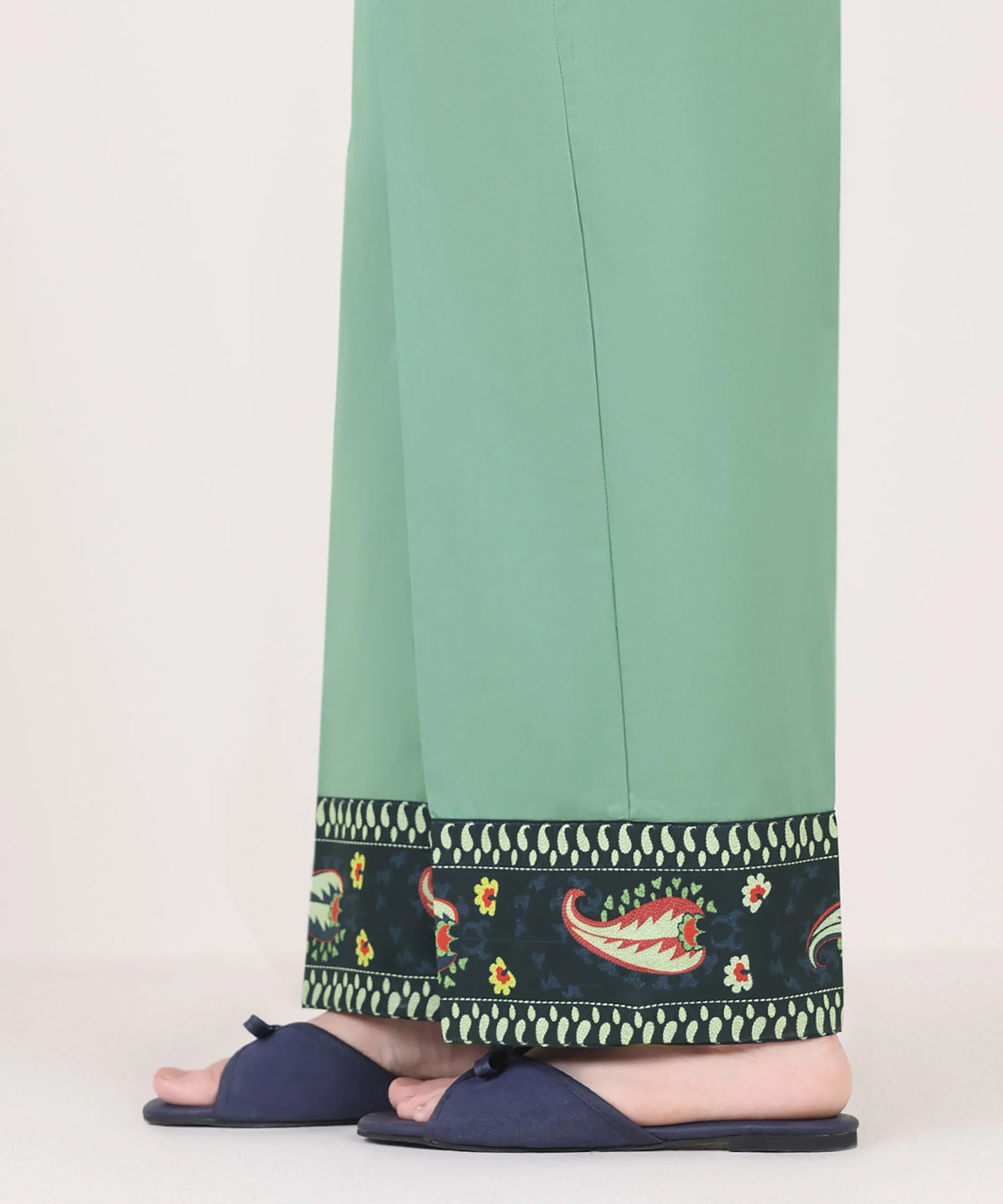 Woman side view mid-length Sapphire green cambric pants printed paisley floral border side slit – Punjabi suits Canada