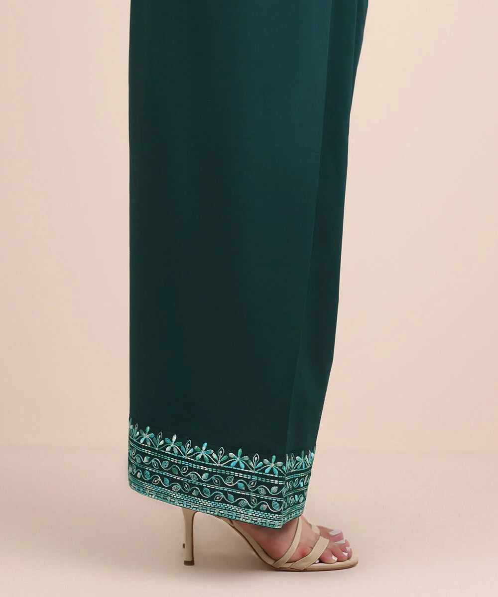 Woman side view mid-length Sapphire green cambric shalwar embroidered floral hem – Pakistani suits online Canada