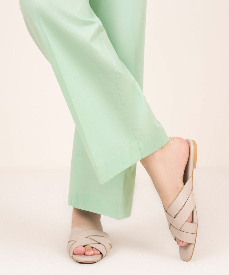 Woman walking angled side view Sapphire green cambric straight pants side slit hem – Punjabi suits Canada