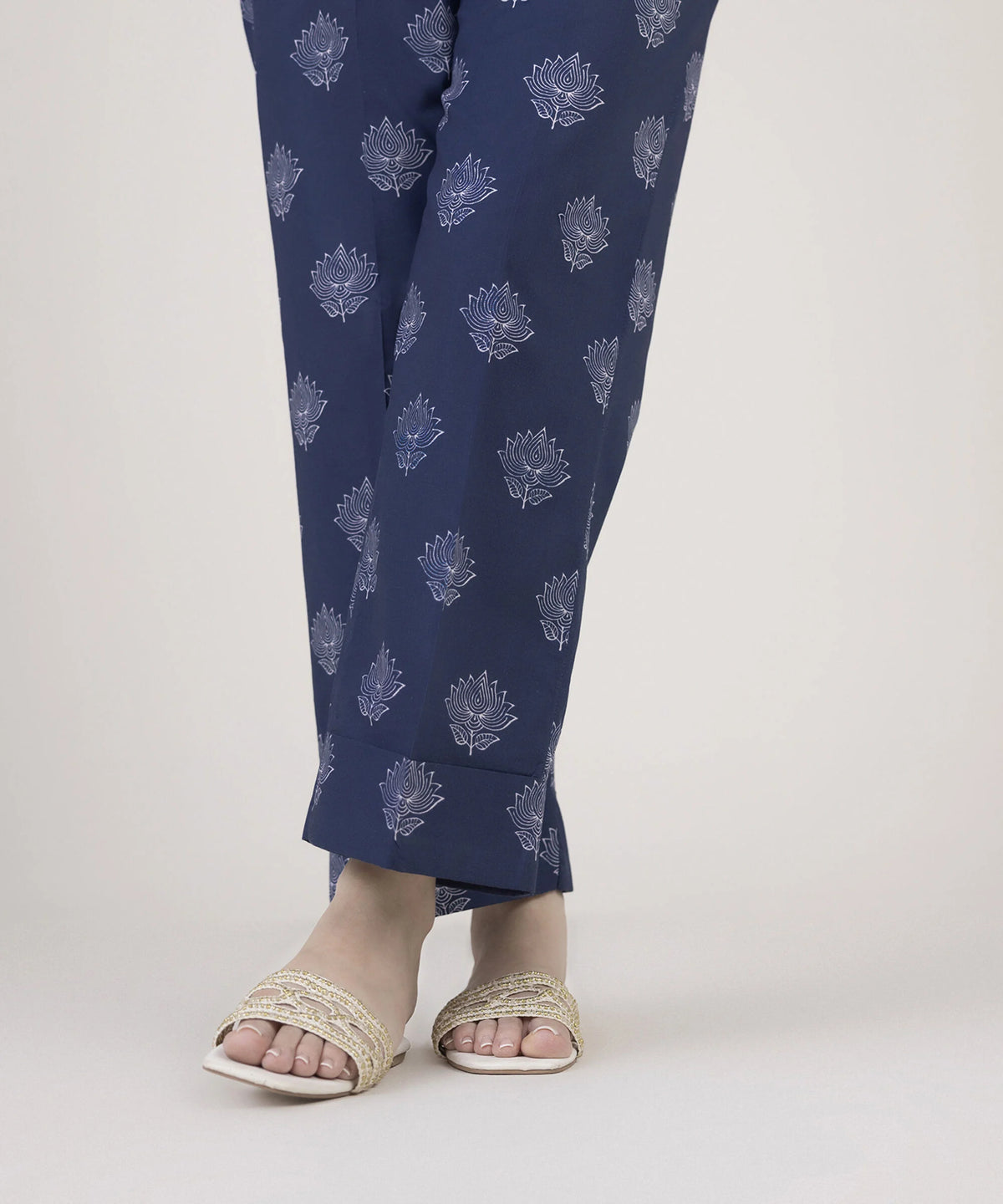 Woman side close-up of right leg wearing Sapphire navy cambric Punjabi suits straight pants lotus print plain cuff hem Canada