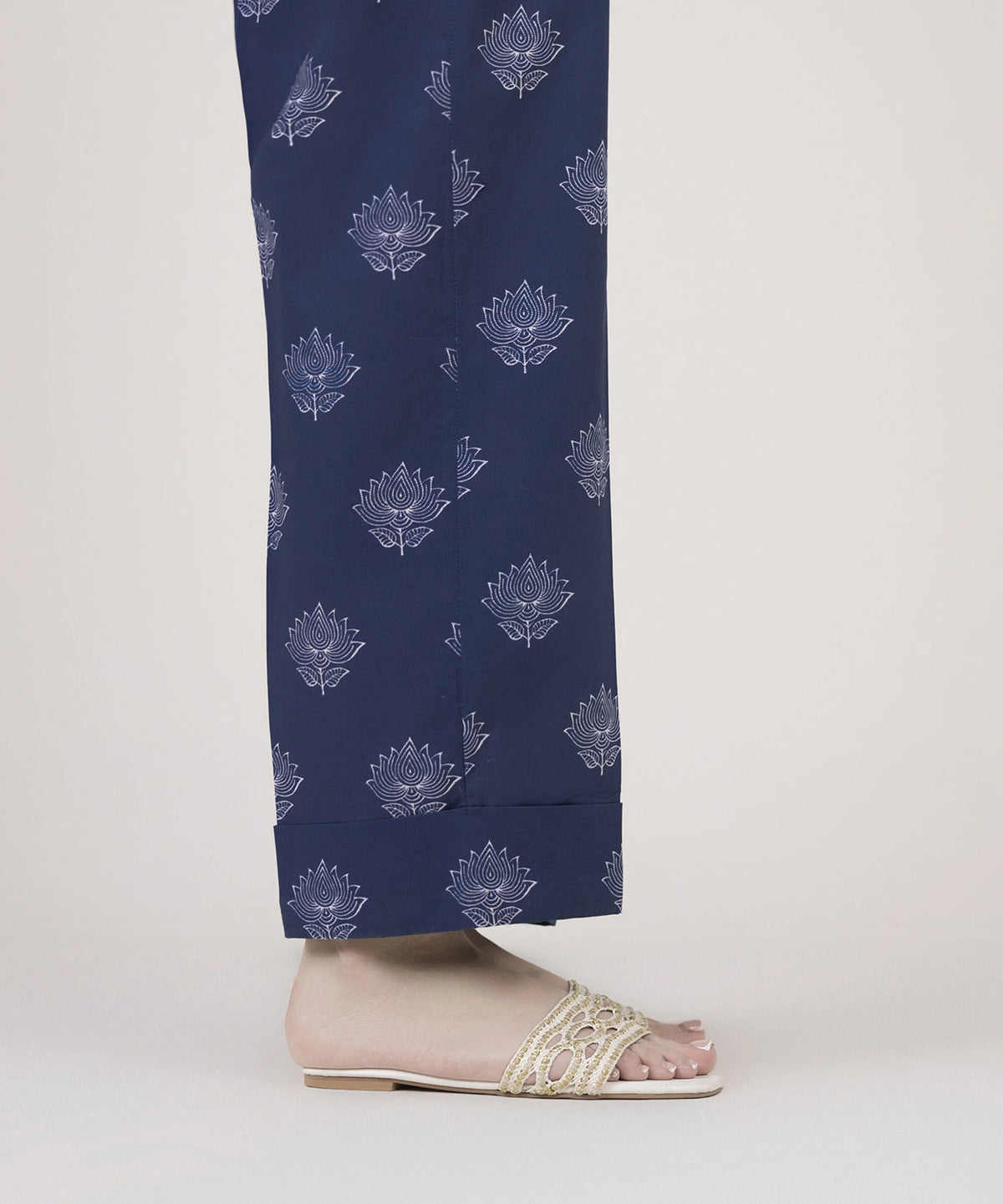 Woman side close-up Sapphire navy Pakistani suits cambric straight pants lotus print cuff slit hem Dewali