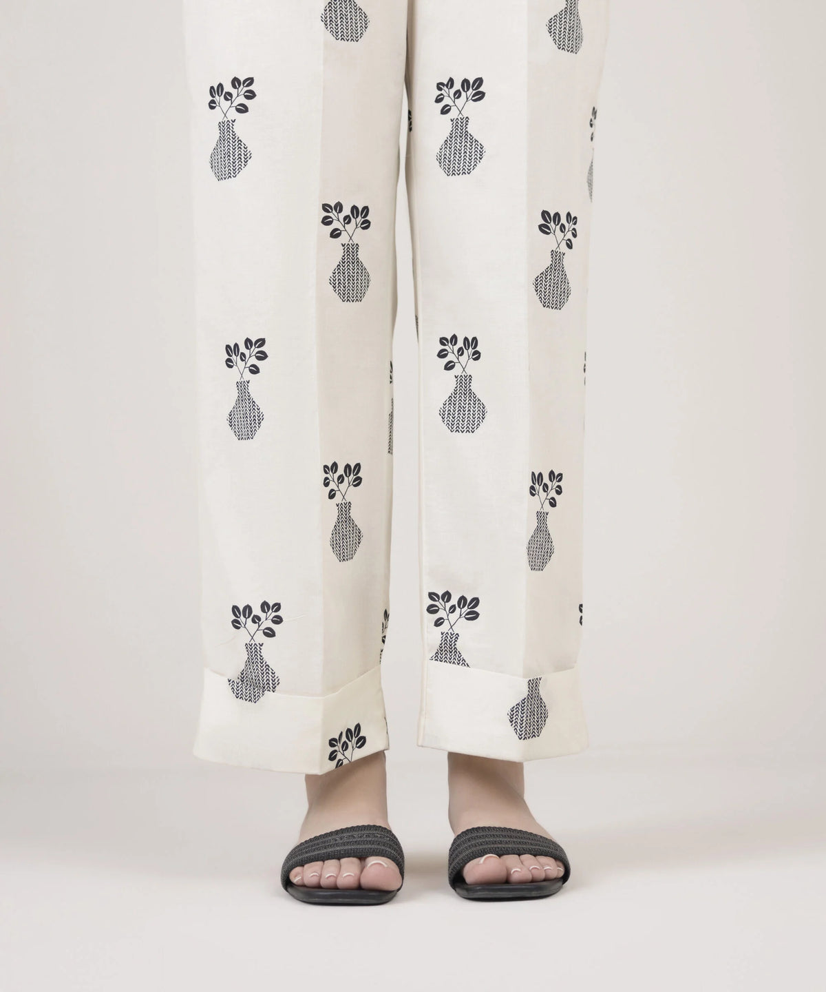 Woman standing front view Sapphire off-white Pakistani suits Canada cambric straight pants vase leaf block print