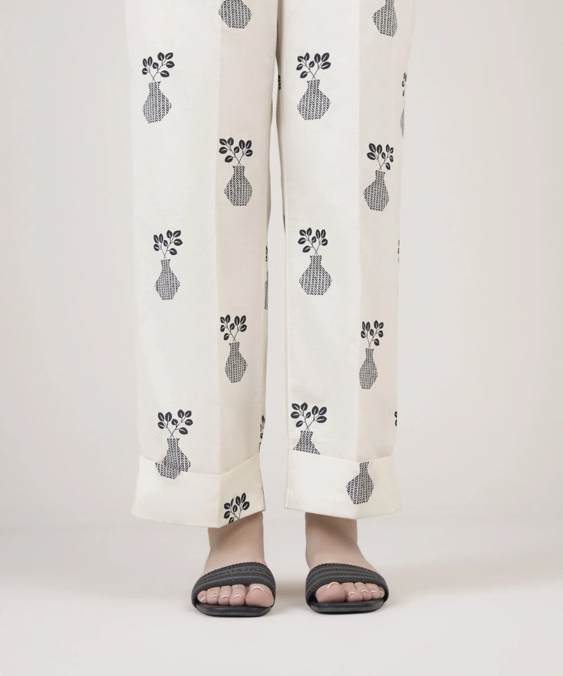 Woman standing front view Sapphire off-white Pakistani suits Canada cambric straight pants vase leaf block print
