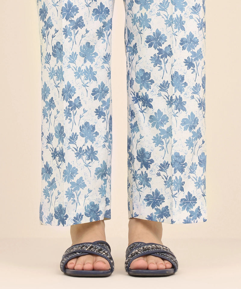 Woman standing front view Sapphire white Pakistani suits Canada cambric straight pants blue floral print women