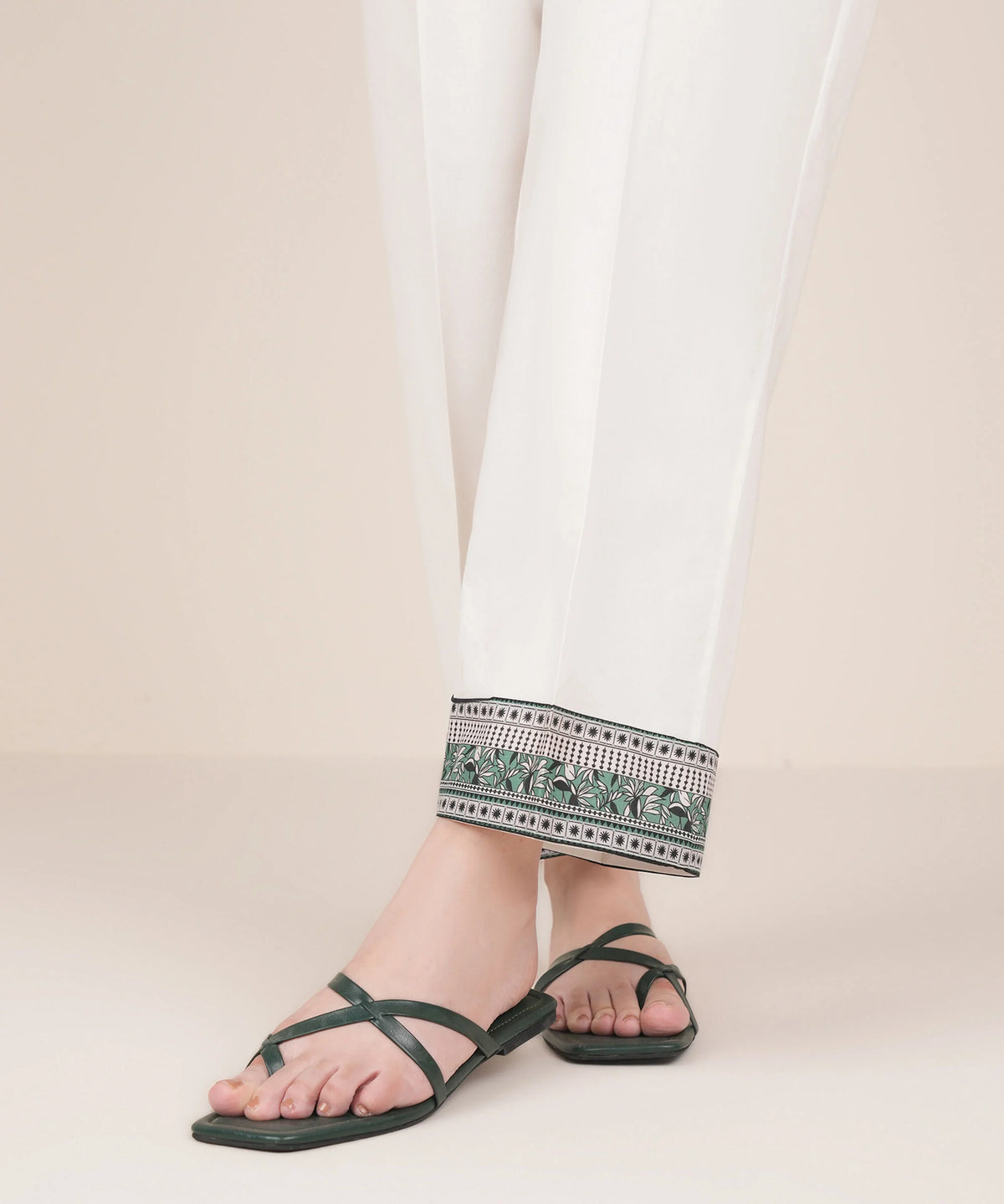 Woman close-up angled view Sapphire white cambric straight pants printed hem border – Pakistani suits Canada