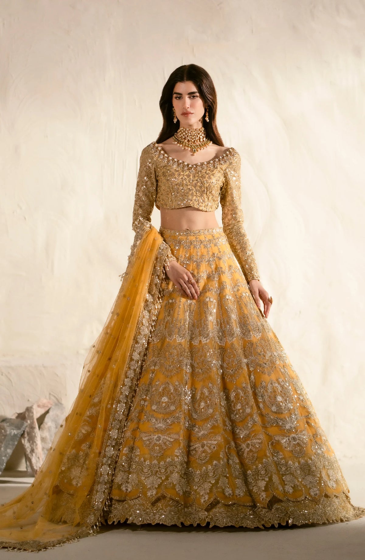 Luxurious golden lehenga set with intricate embroidery and beadwork, featuring a crop top blouse, full circle skirt, and matching dupatta