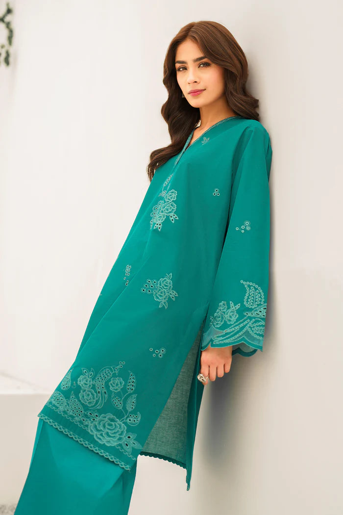 e profile of teal embroidered Pakistani outfit showcasing elegant silhouette, detailed embroidery work, and traditional formal wear styling