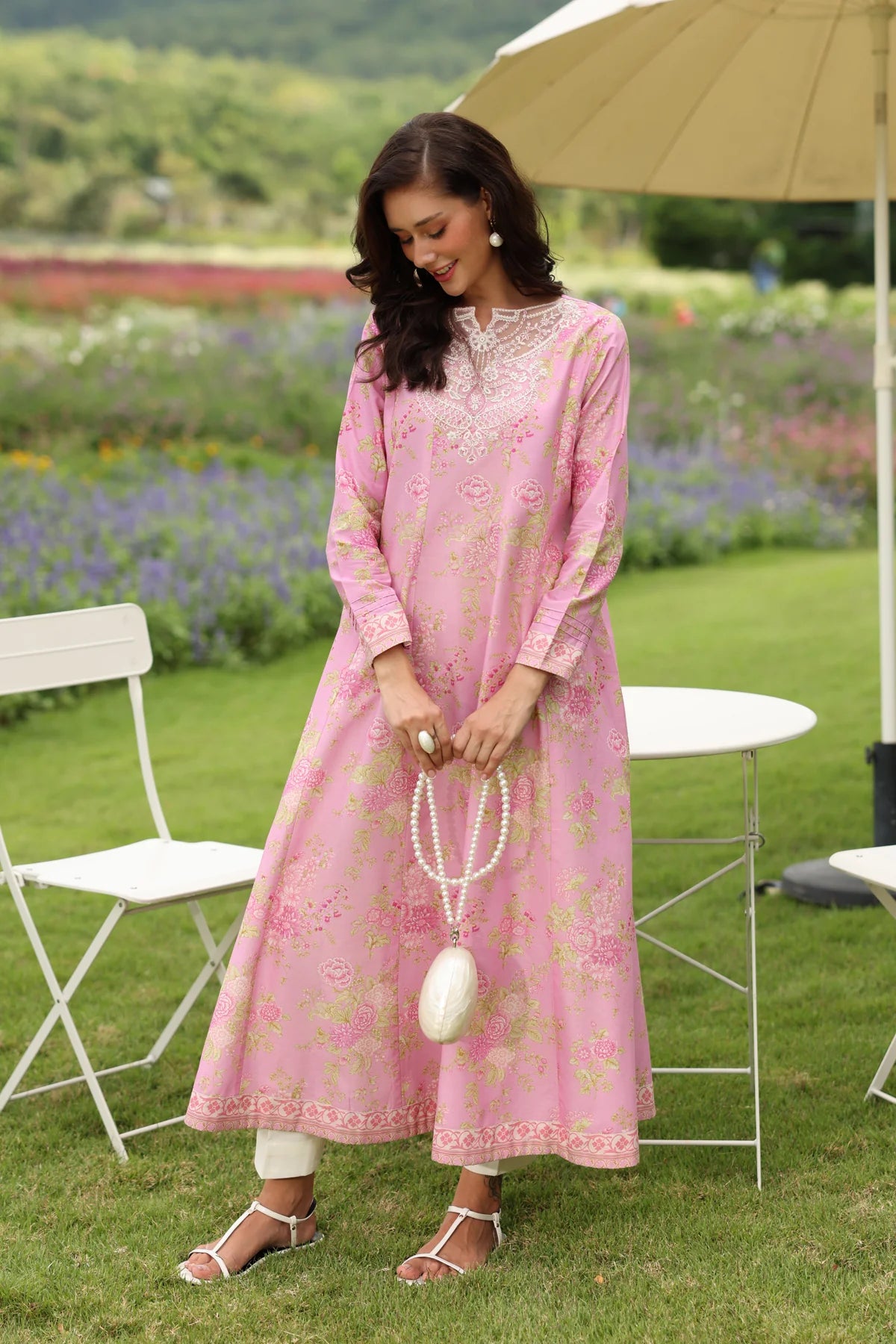 Woman standing full length looking to the ground showing front Xenia dress pink embroidered lawn gown 2-piece Diwali Eid Pakistani suits Canada
