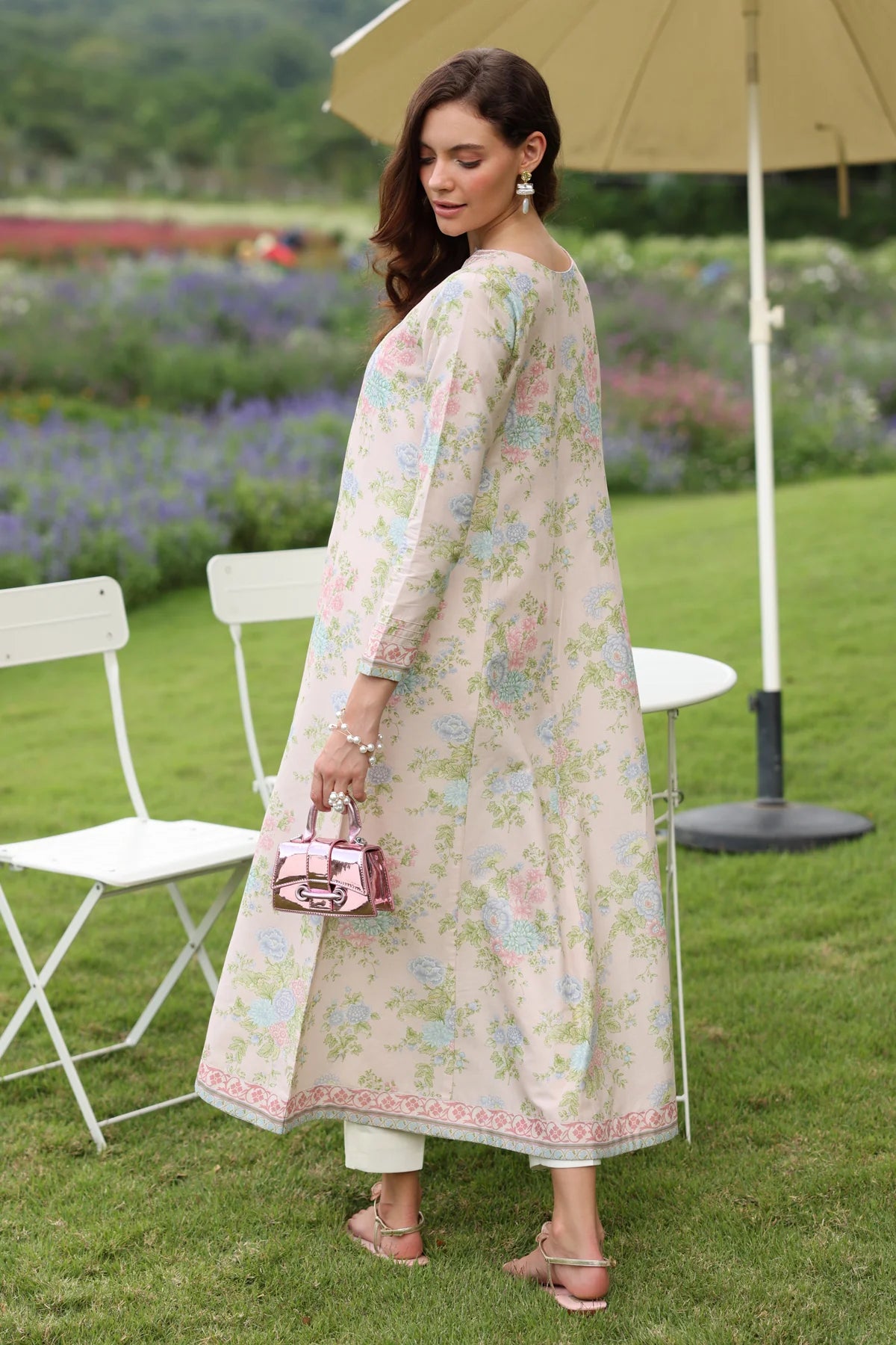 Woman standing full length back side angle Xenia cream pastel floral lawn gown A-line embroidered hem wedding Pakistani suits Canada