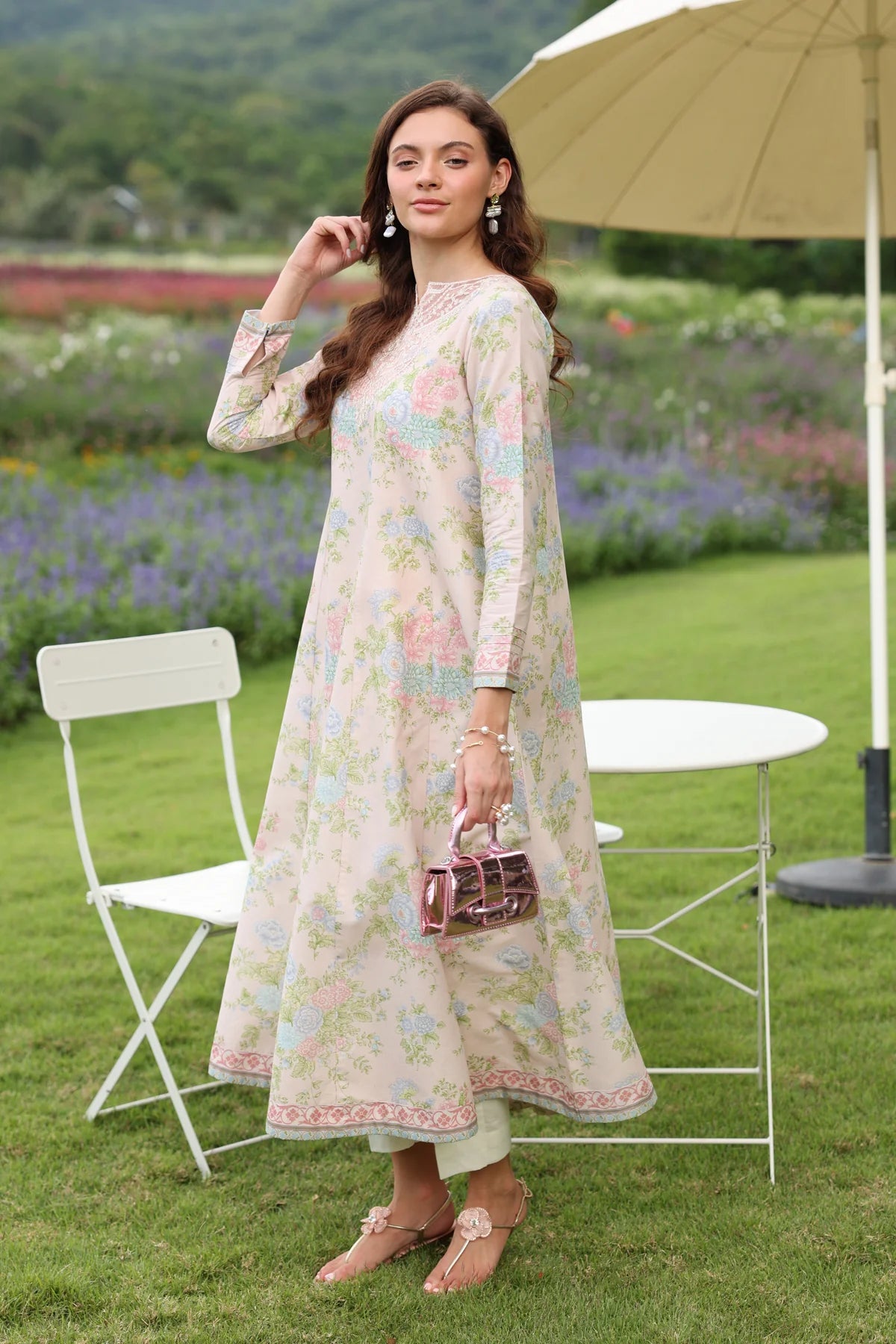 Woman standing full length side view Xenia cream pastel floral lawn gown A-line silhouette embroidered hem Pakistani suits Canada