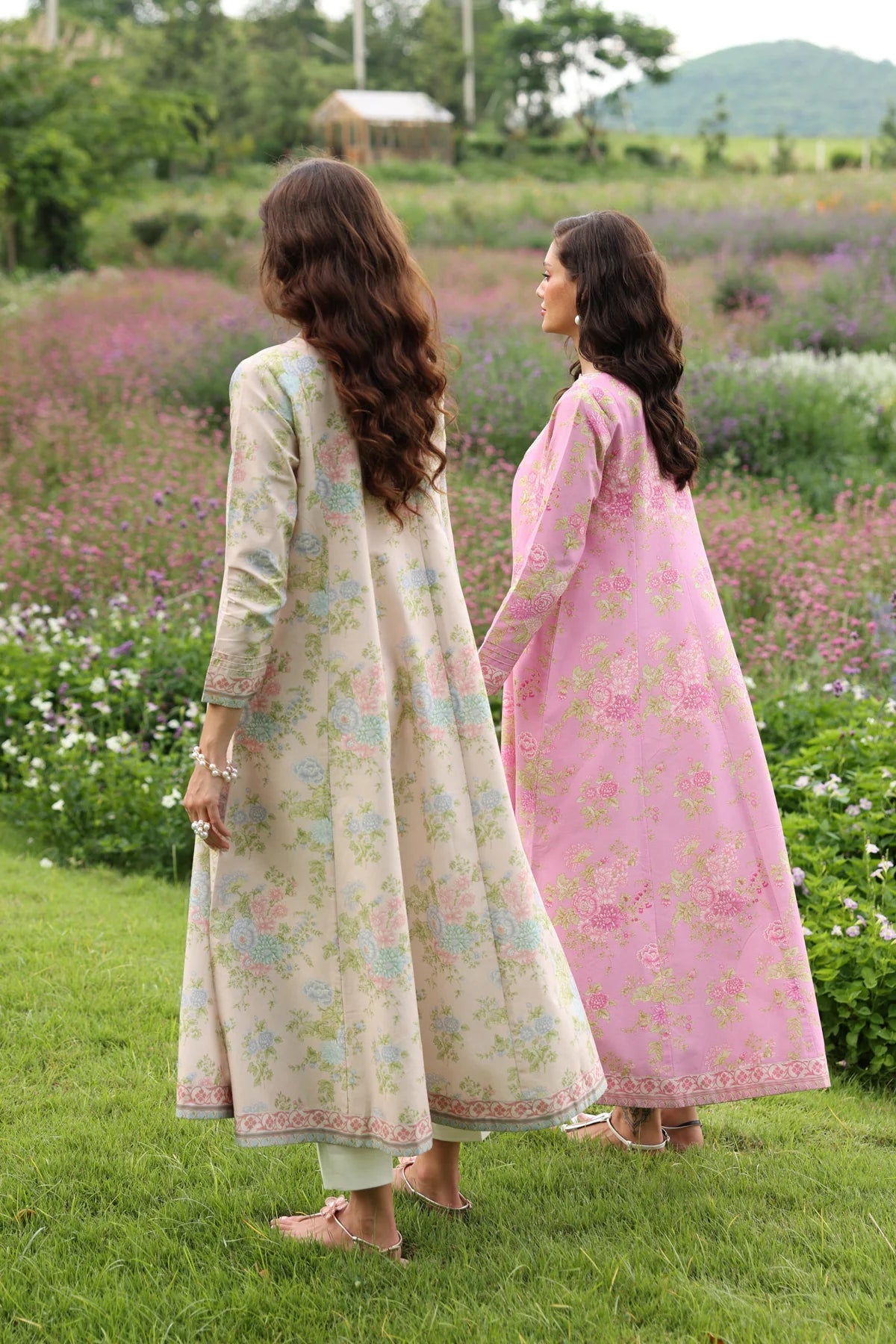 two Women walking full length side view Xenia cream pastel floral lawn gown embroidered hem Eid festive Punjabi suits Canada