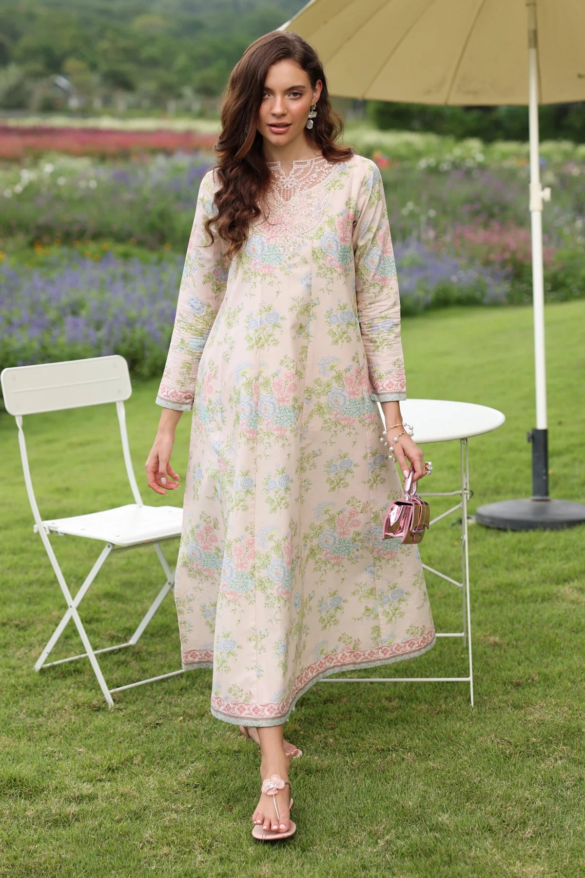 Woman standing full length front view Xenia cream floral lawn gown embroidered hem border Pakistani suits online Canada