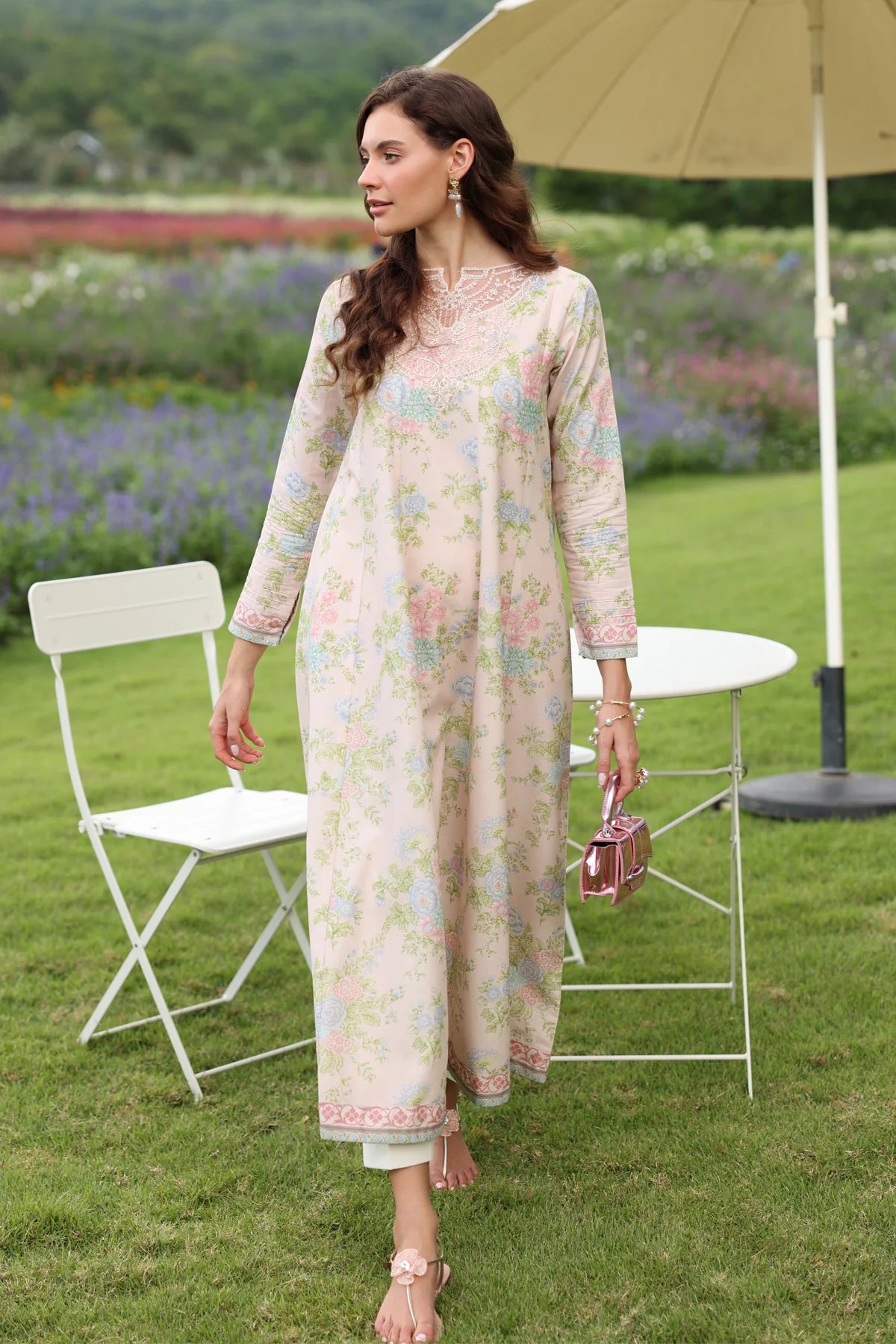 Woman walking full length side view Xenia cream pastel floral lawn gown embroidered hem Eid festive Punjabi suits Canada
